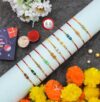 RAJKRITI Combo of 10 Dora Rakhi Set for Brother, Bhaiya, Bhabhi for Rakhi/Rakshabandhan with Roli Chawal & Greeting Card | Premium Rakhi Hamper RKHMPR45